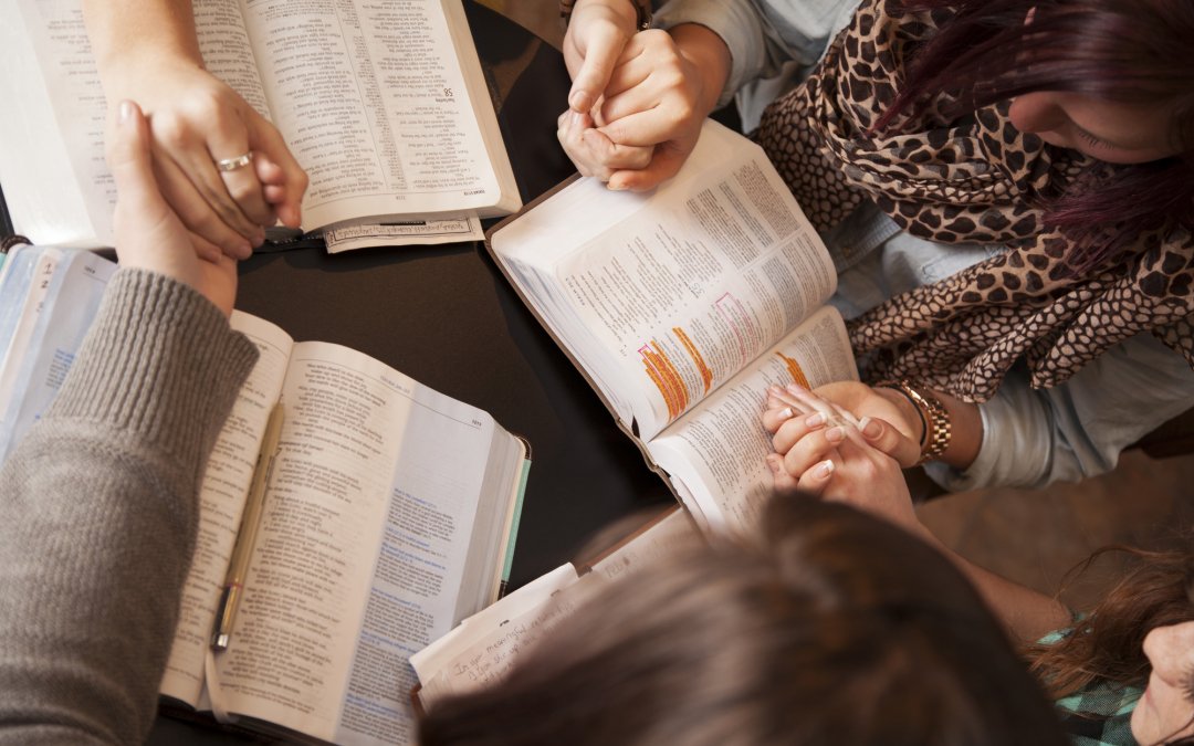 Women with Bibles praying for your purpose